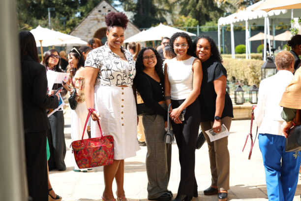 A group of women pose together.